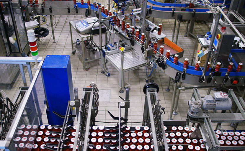View from the top of the line labeling and packaging of the bottles of tomato sauce.
